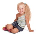 Cheerful little blonde girl in skirt and blouse sitting isolated. Royalty Free Stock Photo
