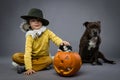 Cheerful little boy with pumpkin, Halloween celebration