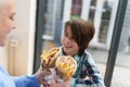 Cheerful little boy and his mother enjoying lunch in a Greek fast food restaurant. Happy Ukrainian family eating together in a Royalty Free Stock Photo