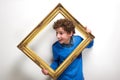 Cheerful little boy holding picture frame Royalty Free Stock Photo