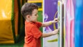 A cheerful little boy is playing in the children's entertainment center on the playground. Royalty Free Stock Photo