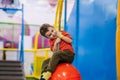 A cheerful little boy is playing in the children's entertainment center on the playground. Royalty Free Stock Photo