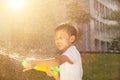 Cheerful little boy playing water guns in the park Royalty Free Stock Photo