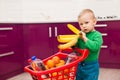 Cheerful little boy with shopping cart. Little boy takes bananas. Shopping, discount, sale concept Royalty Free Stock Photo