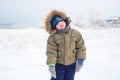 Cheerful little boy standing on a white background