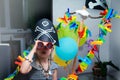 A cheerful little child in a pirate costume plays at home on a cardboard sea ship with a black flag. Fun games at home with family Royalty Free Stock Photo