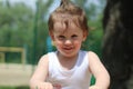 Cheerful little child playing on the playground. Exuberance and vitality of a child enjoying themselves. various activities and