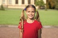 Cheerful little girl adorable ponytails hairstyle outdoors, good mood concept Royalty Free Stock Photo