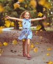 Cheerful little girl in an autumn colorful park