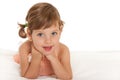 Cheerful little girl on the bedspread Royalty Free Stock Photo