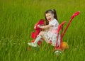 Cheerful little girl goes on a bicycle Royalty Free Stock Photo