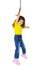 Cheerful little girl hanging on a rope