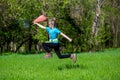 Cheerful little girl jump on the grass with a package Royalty Free Stock Photo