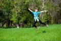 Cheerful little girl jump on the grass Royalty Free Stock Photo