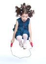 Cheerful little girl jumping on a skipping rope Royalty Free Stock Photo