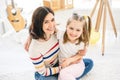 Cheerful little girl with lovely mother