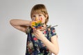 A cheerful little girl with paint on her hands and face and paintbrushes Royalty Free Stock Photo