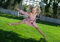 Cheerful little girl in a pink dress jumping Royalty Free Stock Photo