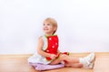 Cheerful little girl in red apron