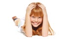 A cheerful little girl with red hair is lying; isolated on white background Royalty Free Stock Photo