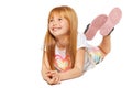 A cheerful little girl with red hair is lying; isolated on the white background Royalty Free Stock Photo