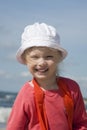 Cheerful little girl on the sea coast Royalty Free Stock Photo