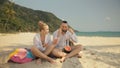 The cheerful love couple holding and eating slices of watermelon on tropical sand beach sea. Romantic lovers two people Royalty Free Stock Photo