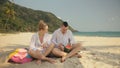 The cheerful love couple holding and eating slices of watermelon on tropical sand beach sea. Romantic lovers two people Royalty Free Stock Photo