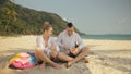 The cheerful love couple holding and eating slices of watermelon on tropical sand beach sea. Romantic lovers two people Royalty Free Stock Photo