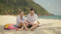 The cheerful love couple holding and eating slices of watermelon on tropical sand beach sea. Romantic lovers two people Royalty Free Stock Photo