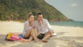 The cheerful love couple holding and eating slices of watermelon on tropical sand beach sea. Romantic lovers two people Royalty Free Stock Photo