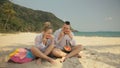 The cheerful love couple holding and eating slices of watermelon on tropical sand beach sea. Romantic lovers two people Royalty Free Stock Photo