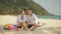 The cheerful love couple holding and eating slices of watermelon on tropical sand beach sea. Romantic lovers two people Royalty Free Stock Photo