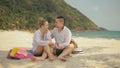 The cheerful love couple holding and eating slices of watermelon on tropical sand beach sea. Romantic lovers two people Royalty Free Stock Photo