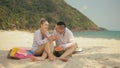 The cheerful love couple holding and eating slices of watermelon on tropical sand beach sea. Romantic lovers two people Royalty Free Stock Photo