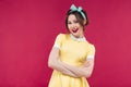 Cheerful lovely pinup girl in yellow dress standing and smiling Royalty Free Stock Photo