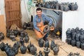 Cheerful male artisan with ceramic vases