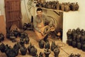 Cheerful male artisan with ceramic vases