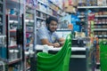 Cheerful male cashier behind convenience store counter Royalty Free Stock Photo