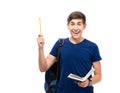 Cheerful male student holding book and pencil