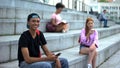 Cheerful male teenager holding smartphone smiling camera, teen messenger app Royalty Free Stock Photo