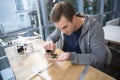 Cheerful male worker is creating a drone Royalty Free Stock Photo