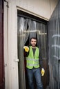 Cheerful male worker in fluorescent vest