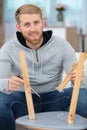 cheerful man assembling wooden stool Royalty Free Stock Photo