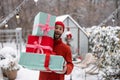 Cheerful man with gift boxes on winter time outdoors Royalty Free Stock Photo