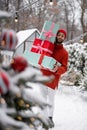 Cheerful man with gift boxes on winter time outdoors Royalty Free Stock Photo