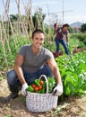 Cheerful man with harvest of vegetables at smallholding Royalty Free Stock Photo