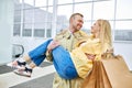 Cheerful man hold cheerful wife in hands after shopping Royalty Free Stock Photo