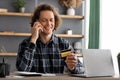 Cheerful Man Holding Credit Card Calling To Bank In Office Royalty Free Stock Photo