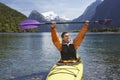 Cheerful Man Holding Up Oar In Mountain Lake